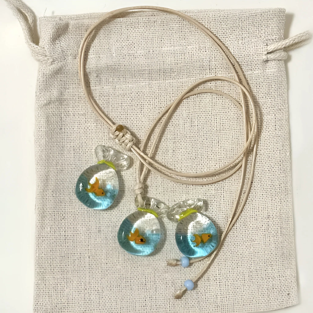 Women's necklace with a coloured glaze skirted joker pendant on a cotton and linen clavicle chain.