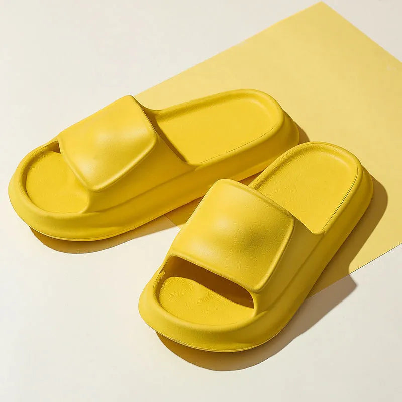 Pair of thick-soled EVA flip flop slippers in purple, showing deep sole profile.