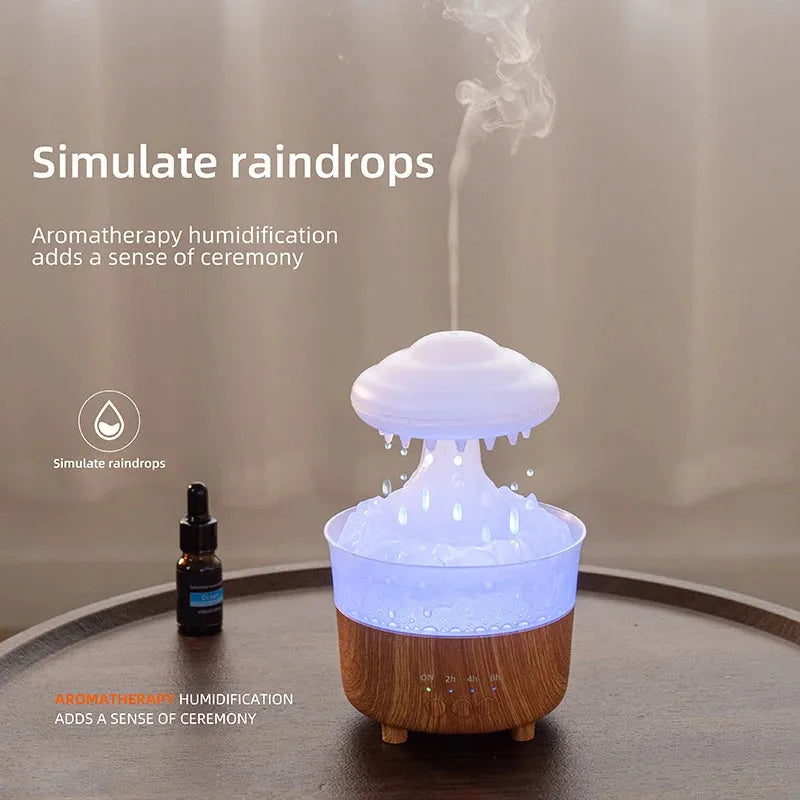 Wood grain white rain cloud shaped humidifier and essential oil diffuser with LED lights on a table.