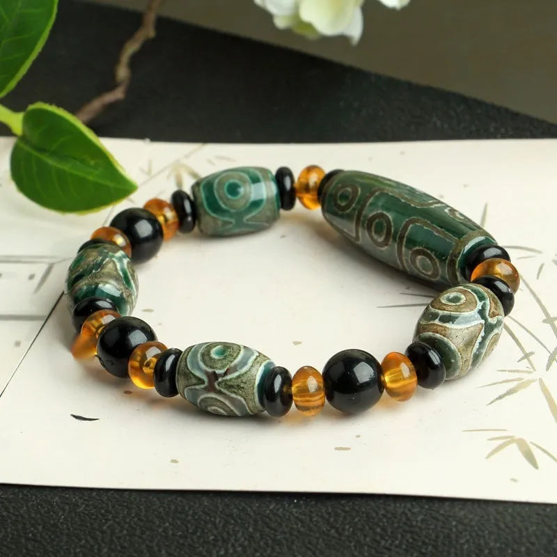 Agate Tibetan dzi bead bracelet with three-eye design and polished finish