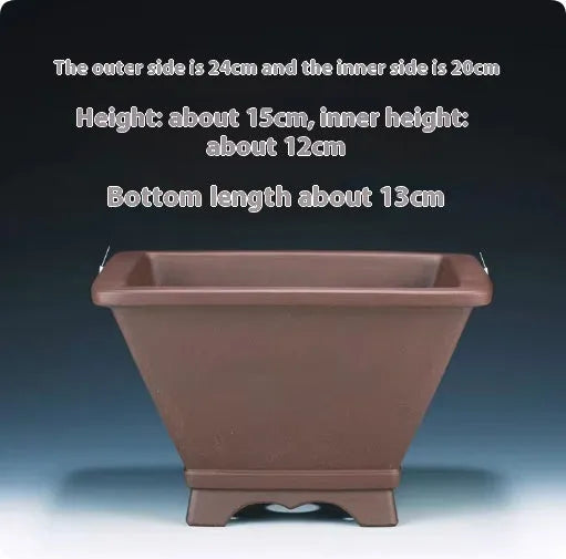 A square purple clay flower pot for succulents or bonsai plants on a tabletop.