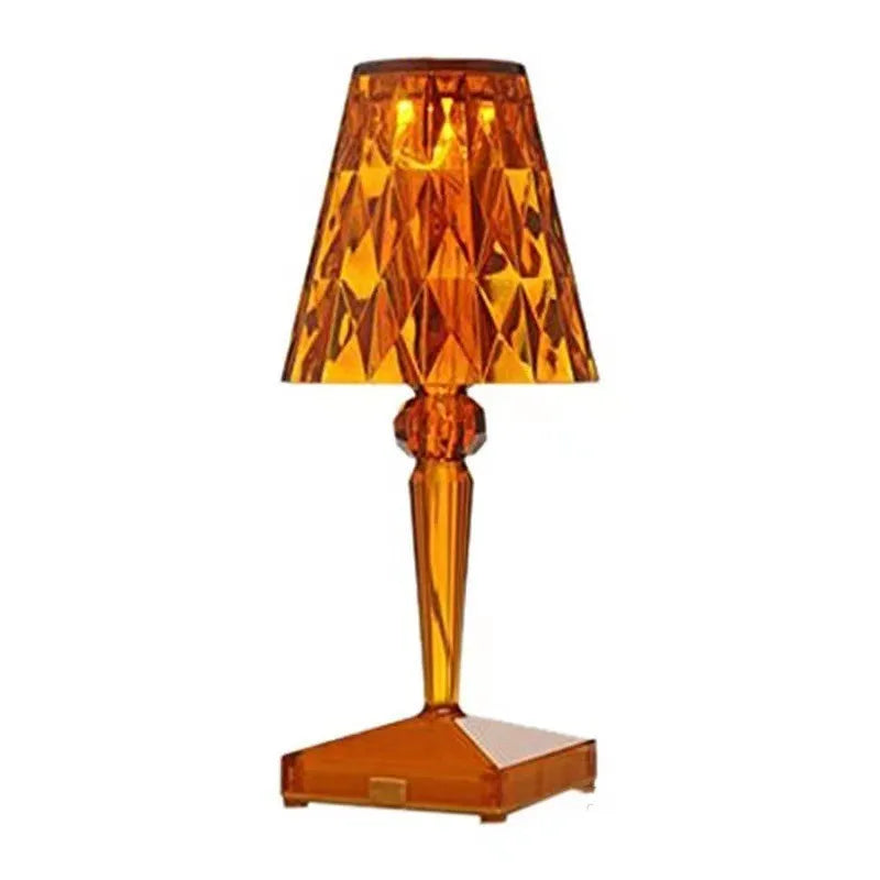 Rose gold portable touch night light with acrylic lamp holder on a surface.