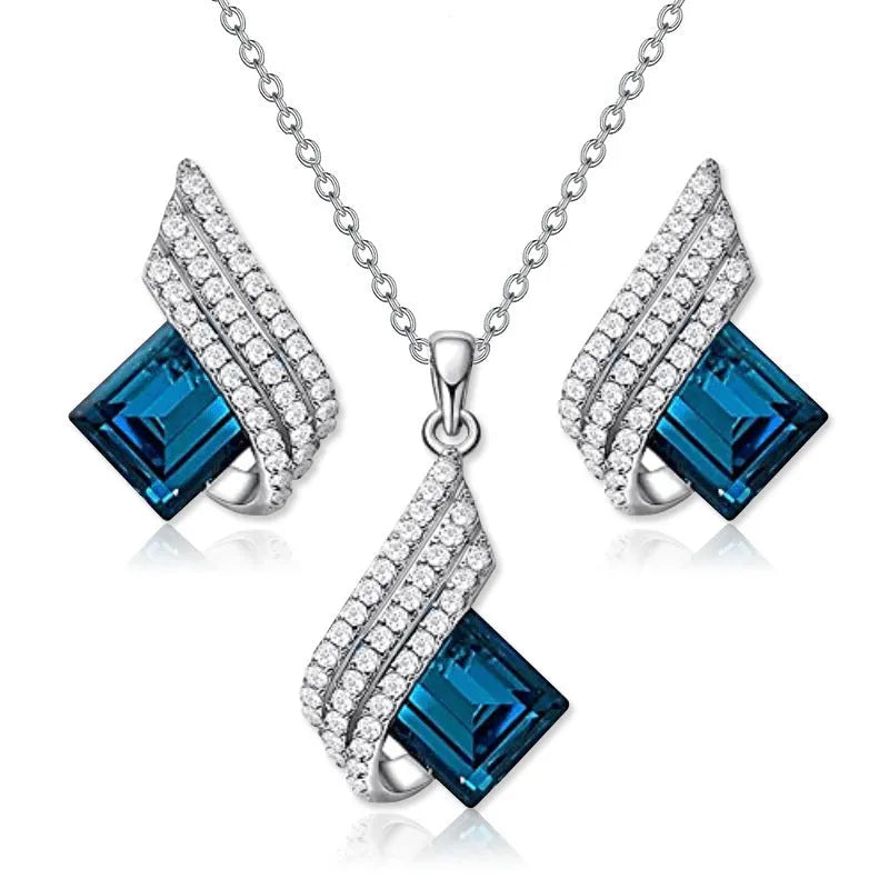 Women's cross chain necklace and earrings set with glass pendant and electroplated finish.