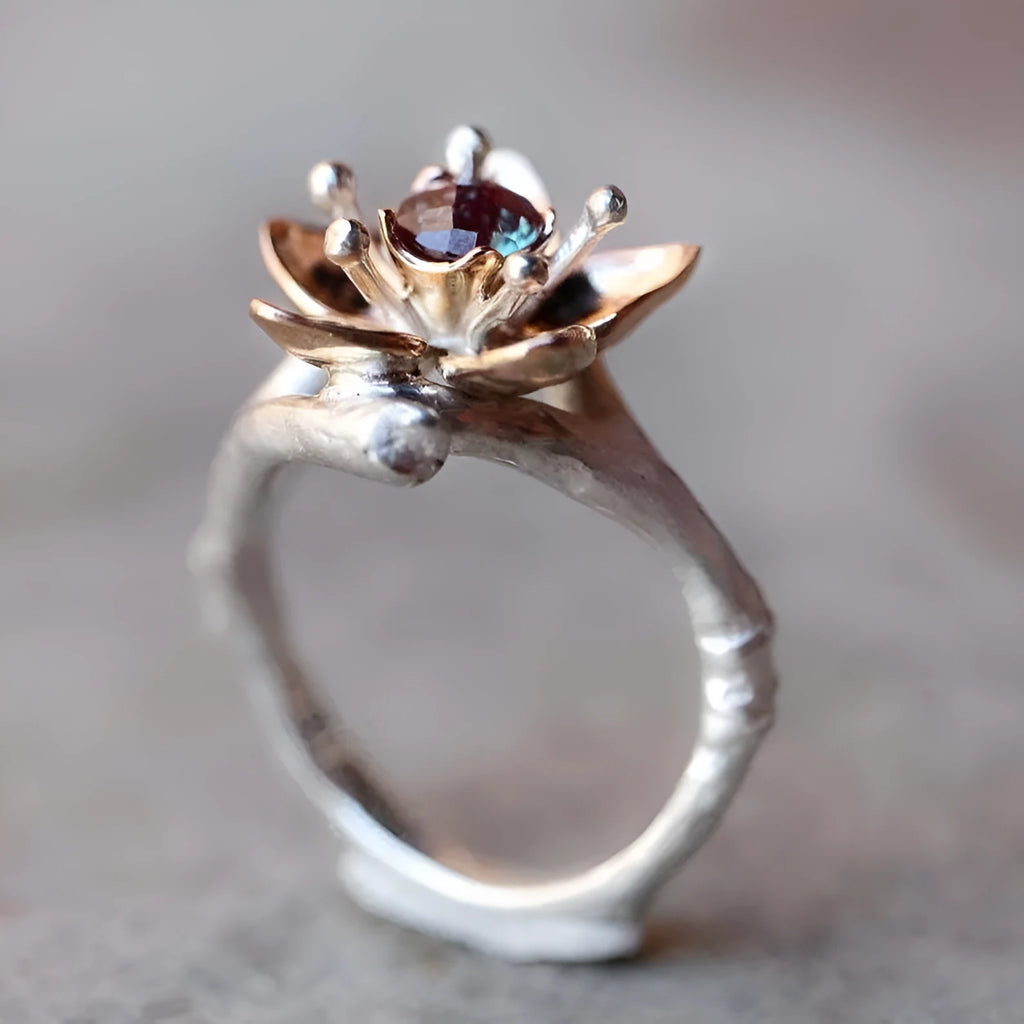 Silver two-tone geometric floral pattern women's alloy ring on a plain background.