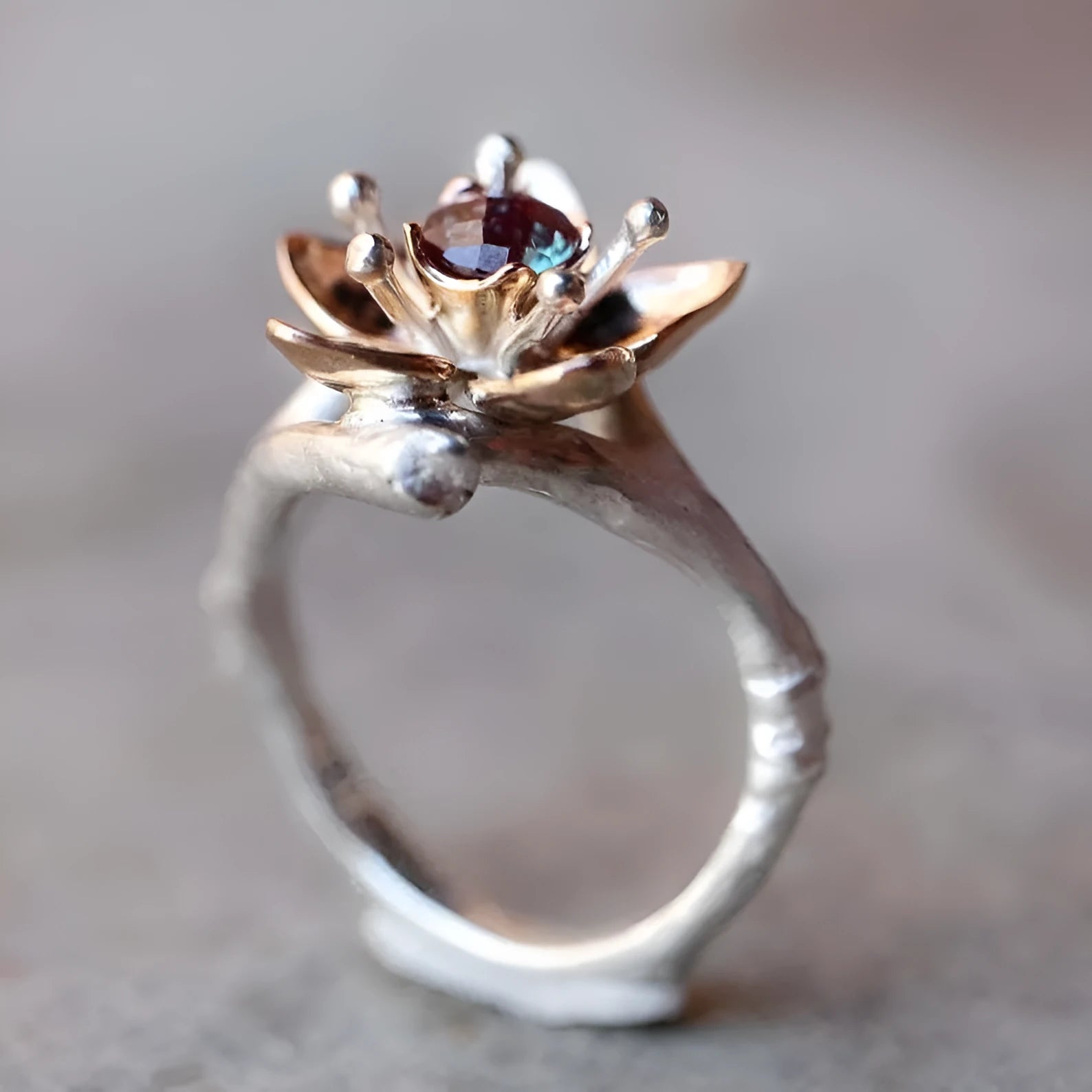 Silver two-tone geometric floral pattern women's alloy ring on a plain background.