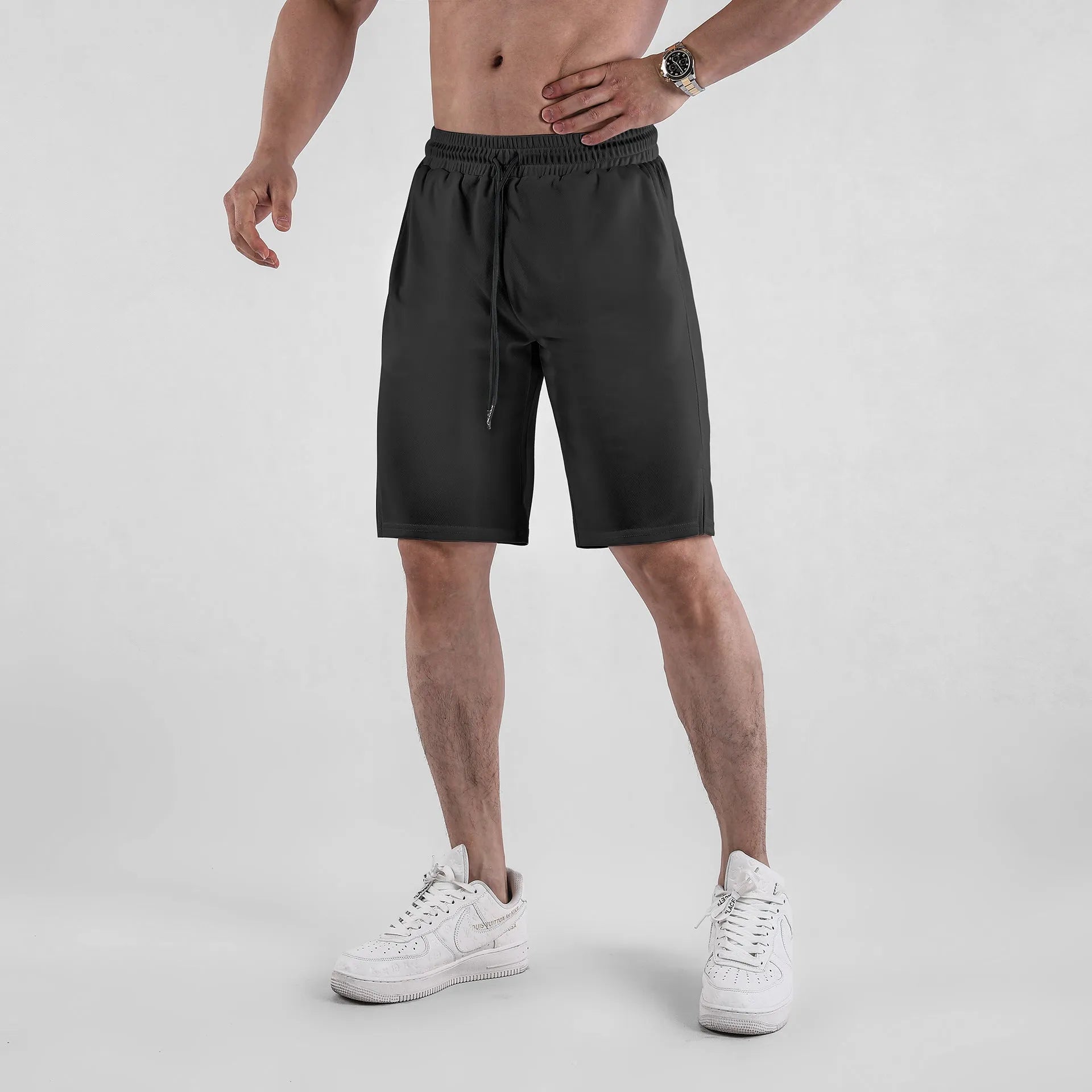 Men's black quick-drying mesh shorts with loose capri pants fit and mid-waist design