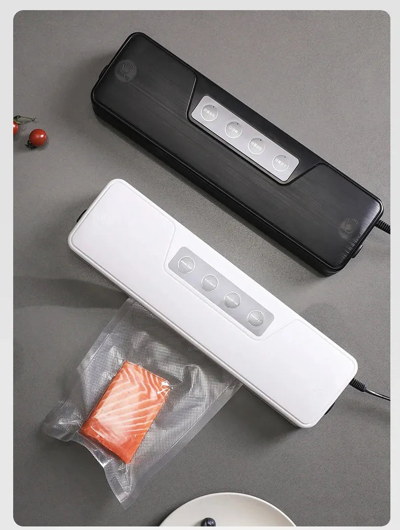 Black compact automatic vacuum sealing machine for home food preservation on a kitchen counter.