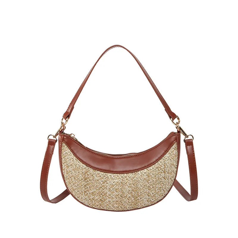 Hard woven straw dumpling-shaped crossbody shoulder bag with organised interior compartments.