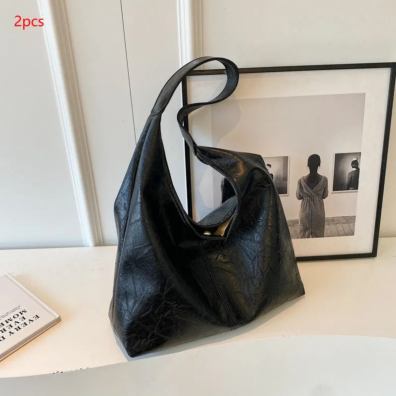 Soft leather shoulder bag in street style with sandwich pockets, shown in multiple colour options.