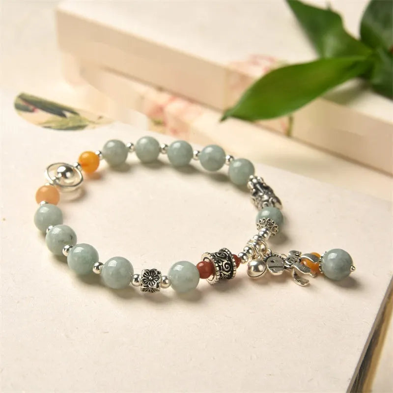 A vintage-style natural jade and alloy metal bracelet bangle for adults, showing retro pony style design.