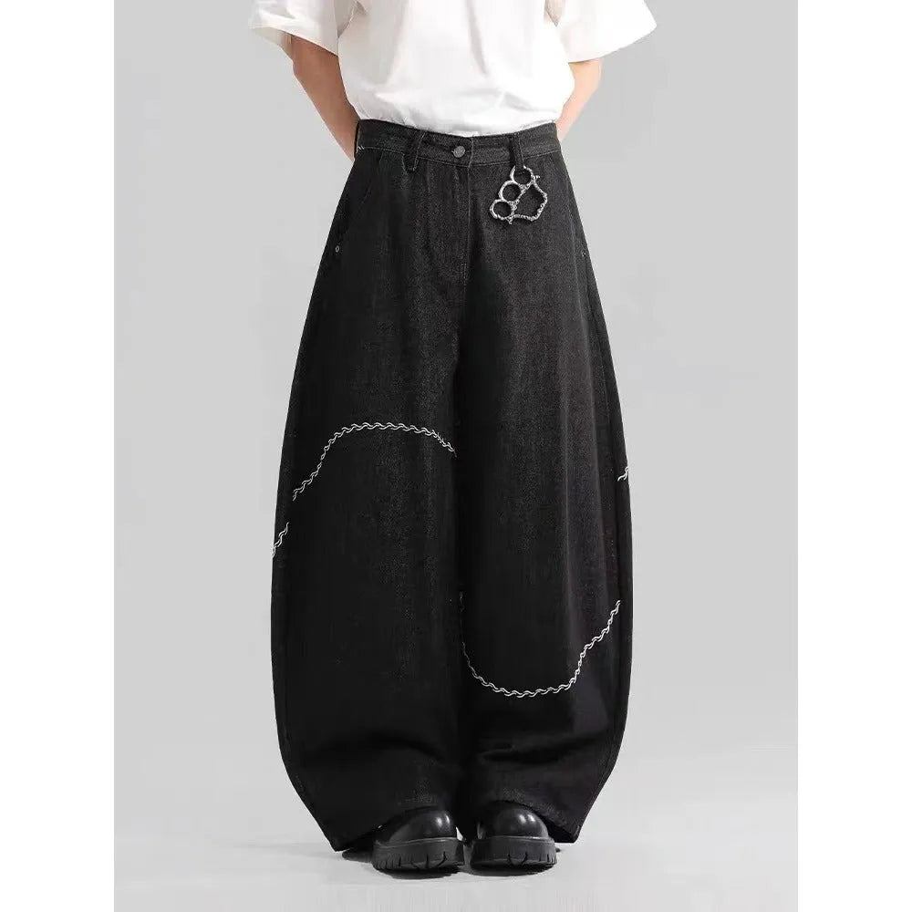 Black straight-leg denim trousers with a mid waist and zip fly, laid flat.