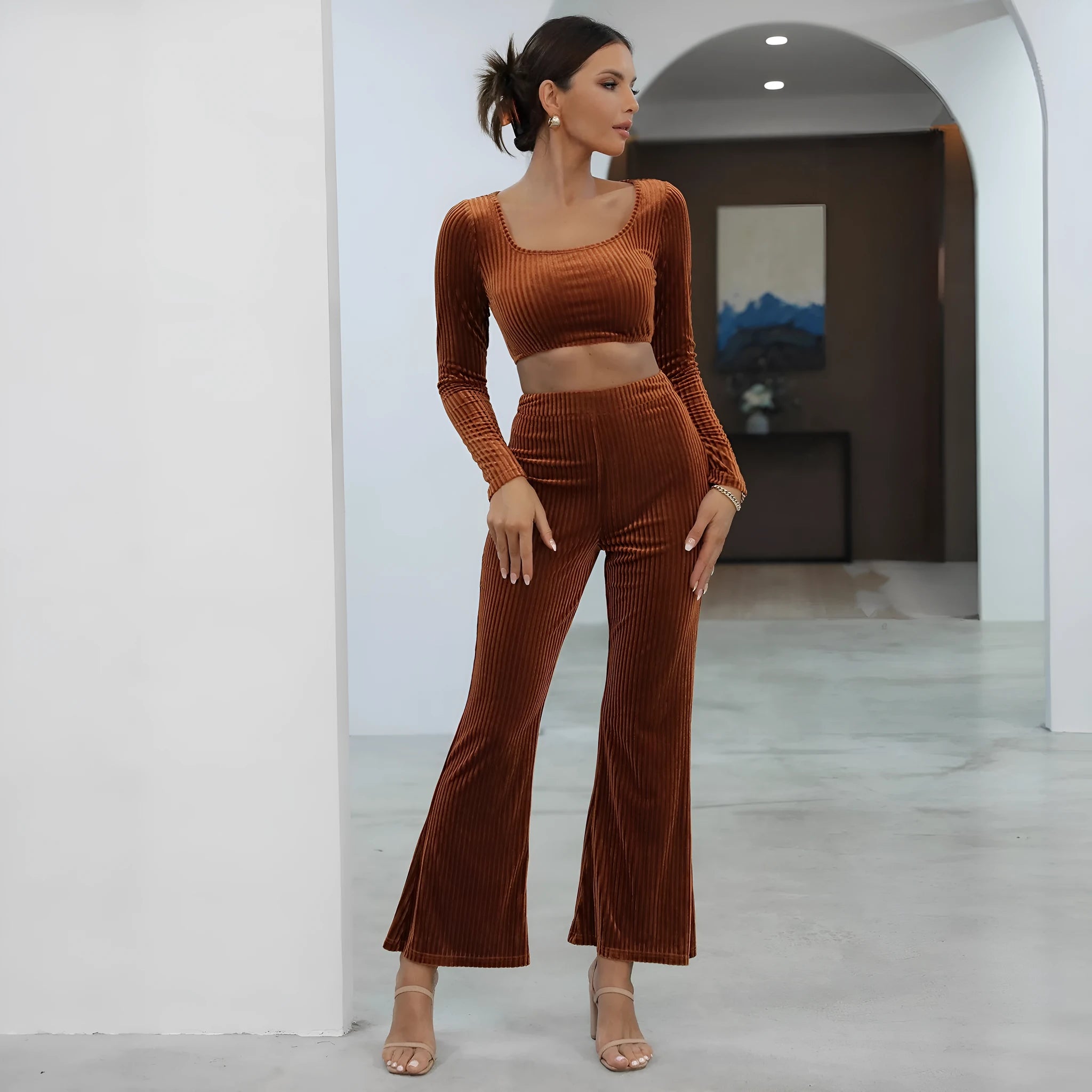 Women's caramel coloured long sleeve sweater and trousers loungewear set on a hanger.