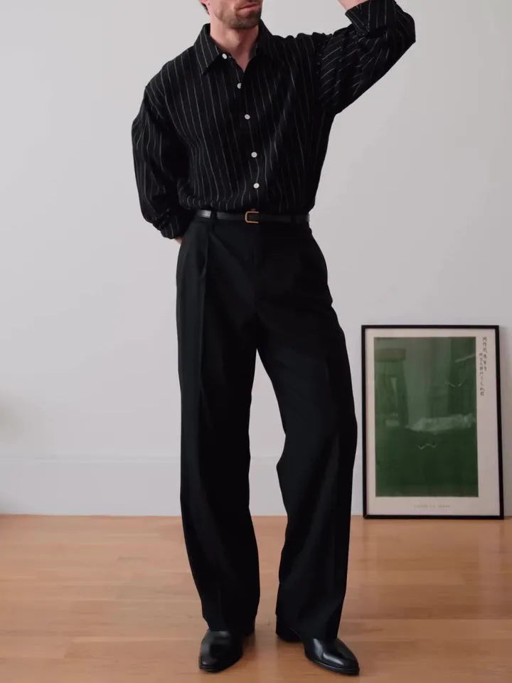 Black and white pinstriped long sleeve button-down shirt on a hanger.