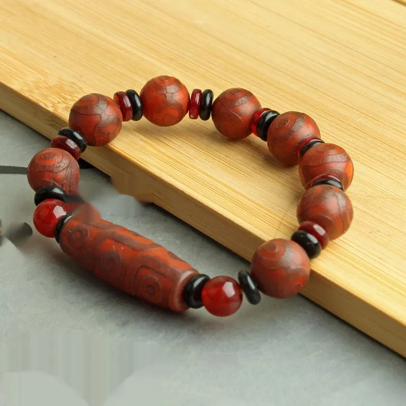 Agate Tibetan dzi bead bracelet with three-eye design and polished finish