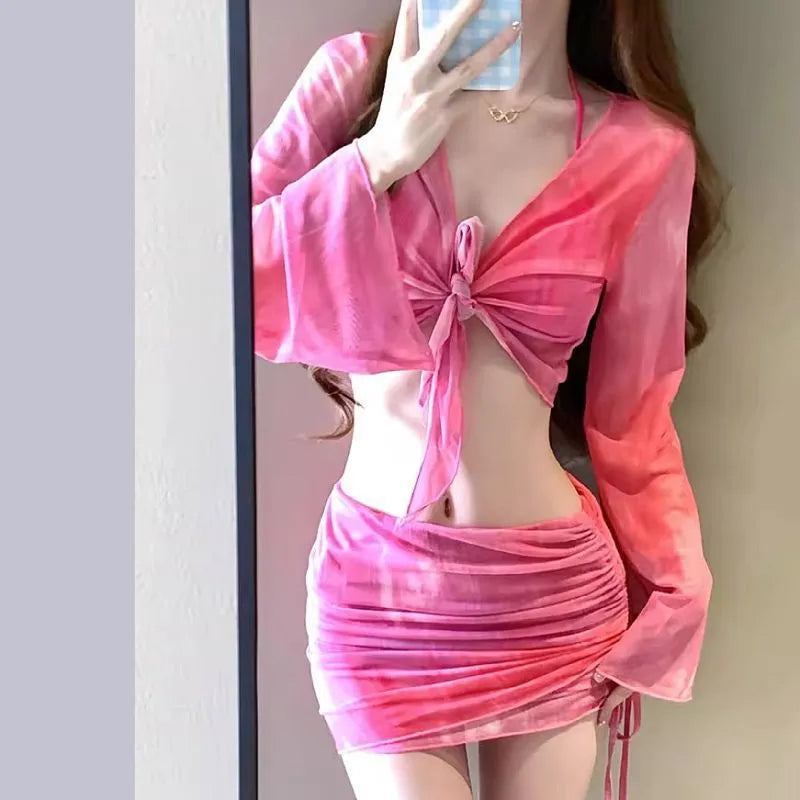 Women's blue high waist swimsuit four-piece set with shirt, bra, underwear, and skirt on beach