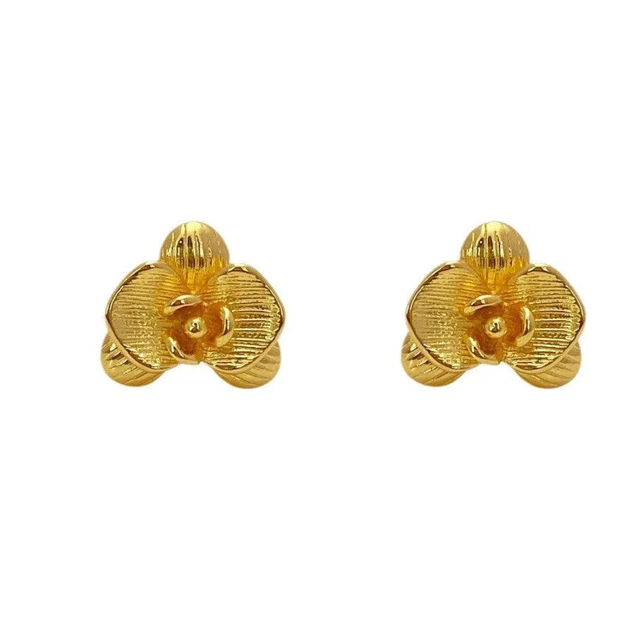 Retro floral fashion earrings in gold or silver colour with petal detailing on copper base.