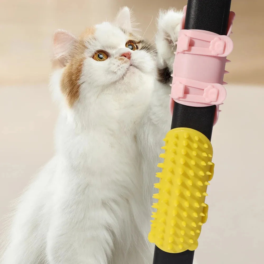 Silicone cat grooming comb with adjustable strap mounted on a table leg, shown in green colour.