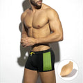 Men's black swimming boxers with white polka dot print and ribbon trim, laid flat.