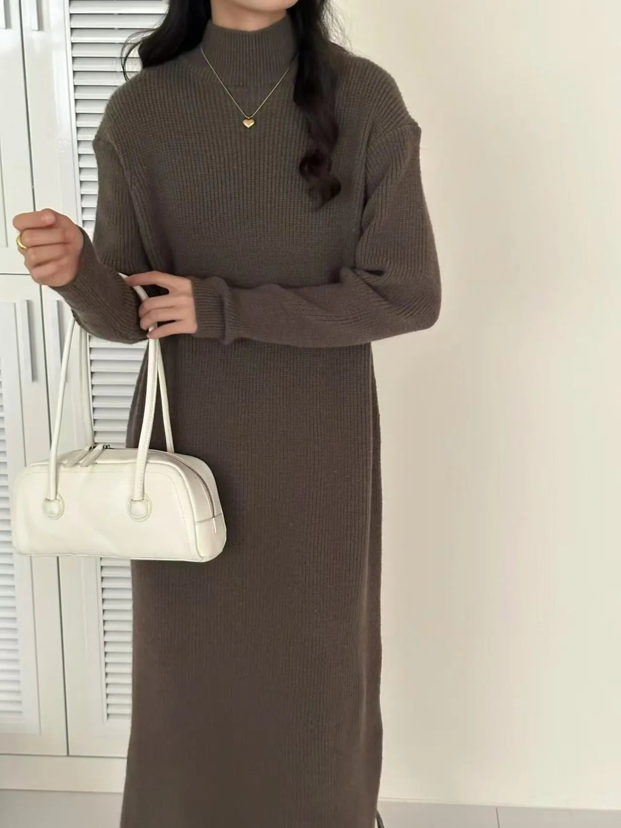 Beige acrylic knit dress with half-turtleneck collar and high waist.