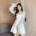 White chiffon patchwork dress with long sleeves and a waist-slimming silhouette on a woman