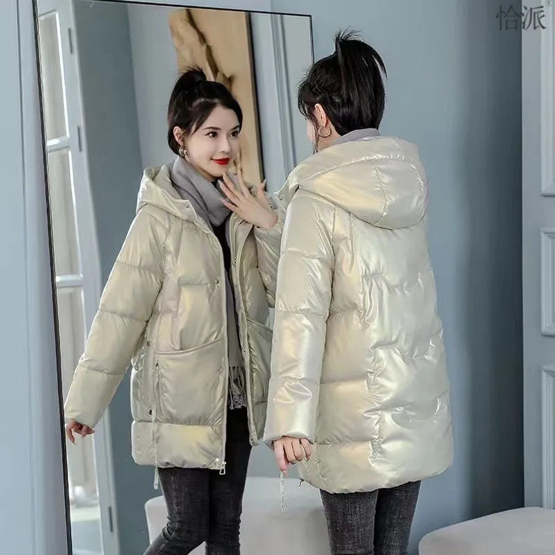 Women's loose fit hooded winter jacket in green colour showing long sleeves and thick insulation