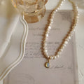 French Court vintage geometry pearl necklace with adjustable perimeter on display