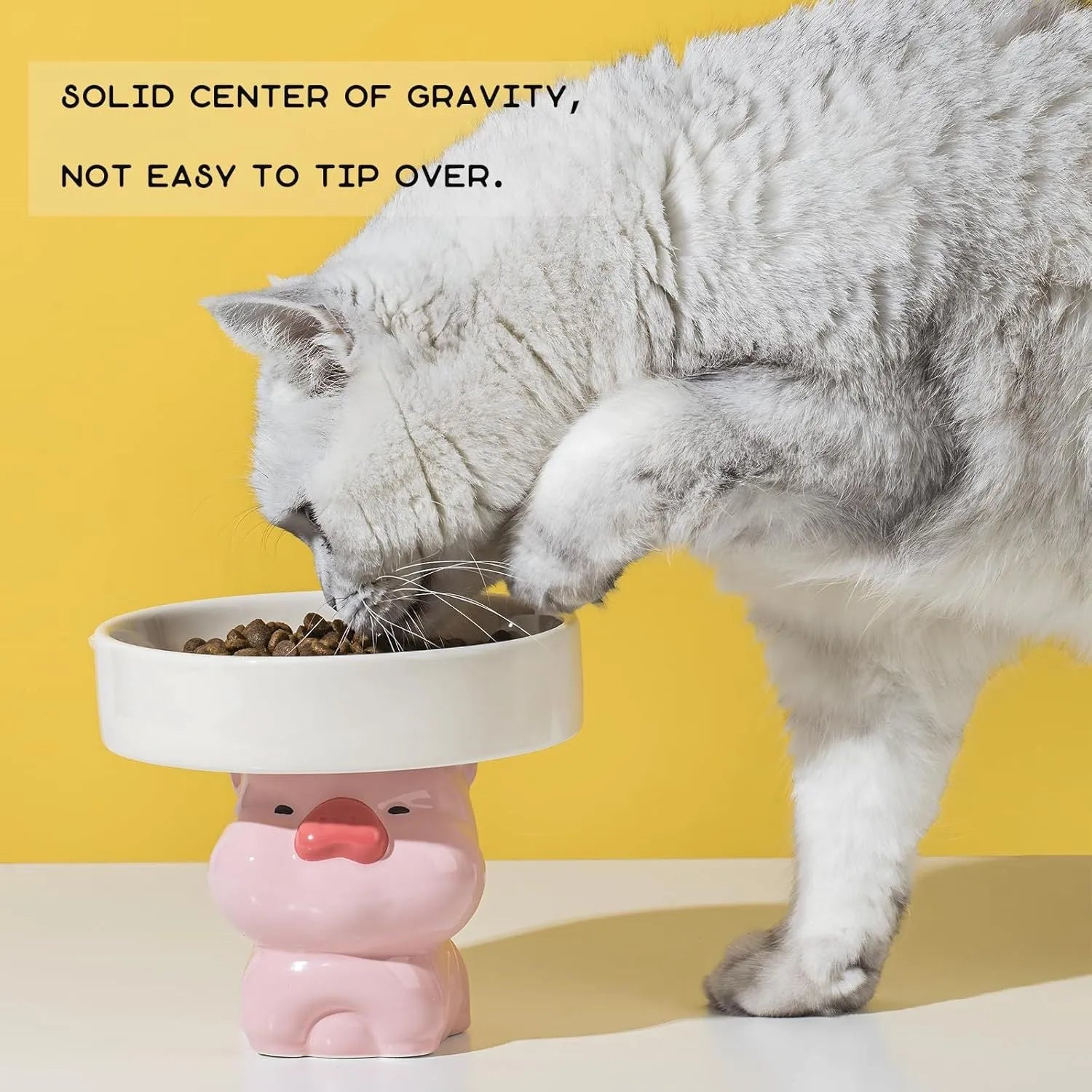 White ceramic raised cat bowl with bear design, showing wide opening and elevated base.