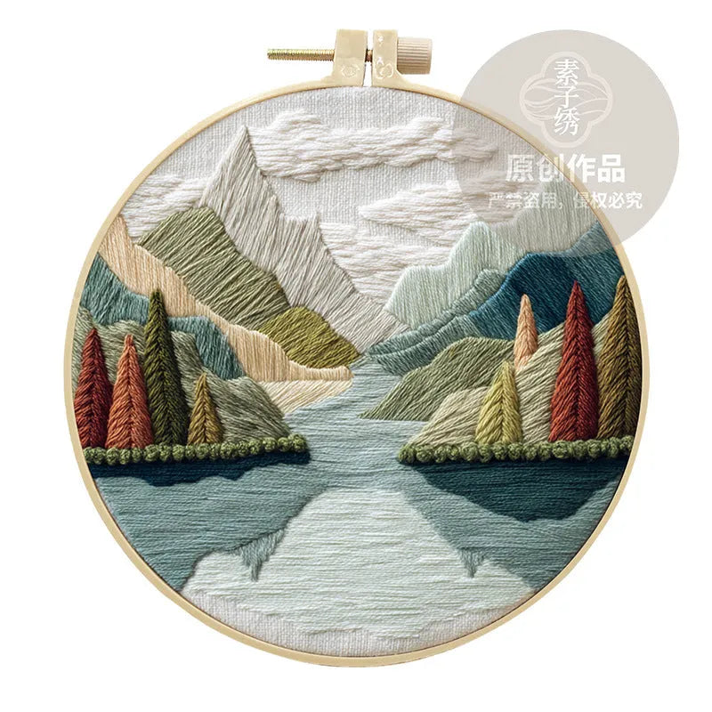 Embroidery DIY kit with printed landscape fabric, embroidery threads, needles, and frame for handmade cloth art