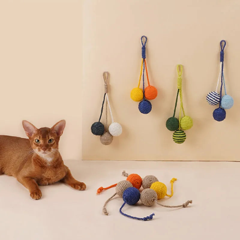 Cat teaser stick toy set with wand and three colourful catnip balls on blue background