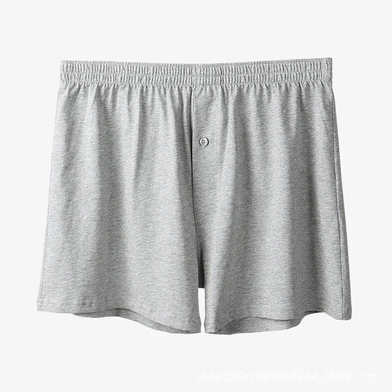 Men's solid-colour cotton boxer shorts with a high-waist, loose fit on a neutral background.