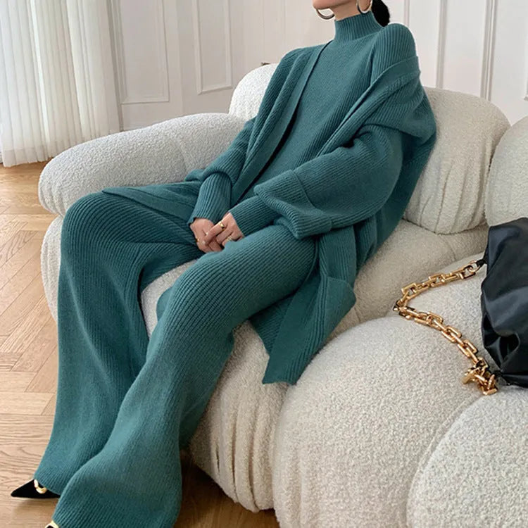 Women's knitted three-piece clothing set showing cardigan, wide-leg trousers, and top with leather stitching detail