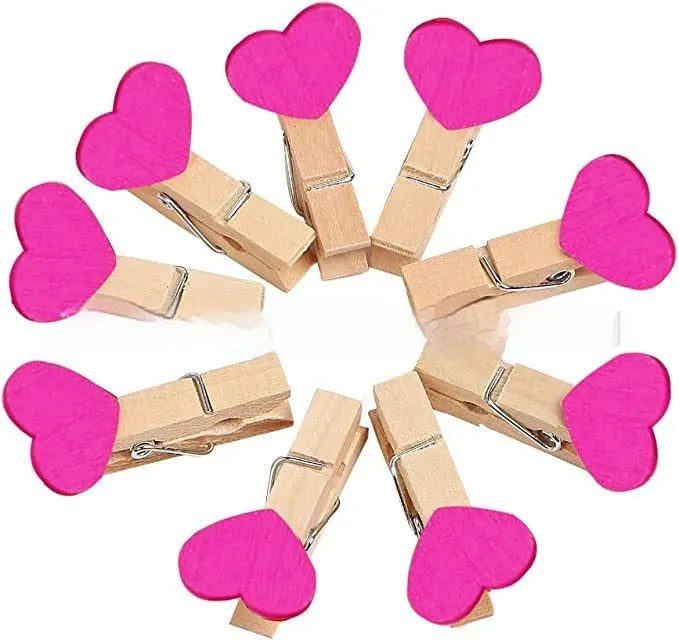 Five solid wood heart-shaped clips in different colours showing handmade construction details