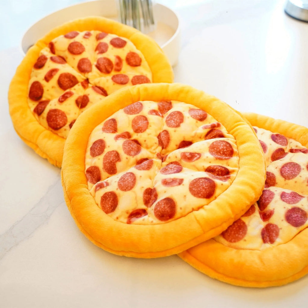 Yellow pizza slice shaped dog chew toy with textured pepperoni and crust details