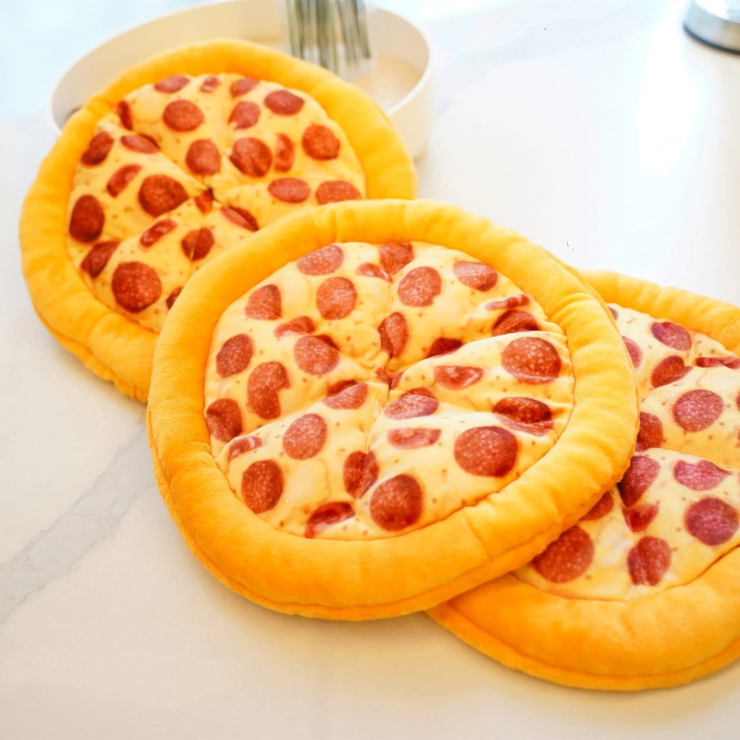 Yellow pizza slice shaped dog chew toy with textured pepperoni and crust details
