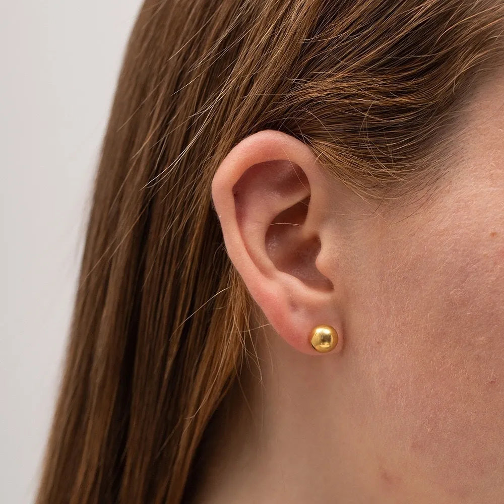 Stainless steel round ball stud earrings on a white background, showing gold and silver plated options.