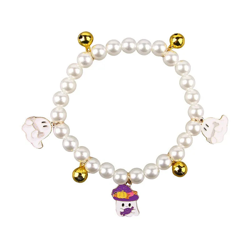 Halloween cat collar with simulated pearls and pumpkin charms in purple ghost, skull, and smiling designs