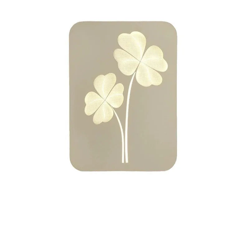 Modern bedside lamp with acrylic shade and iron base showing tricolour LED light and decorative heart design.
