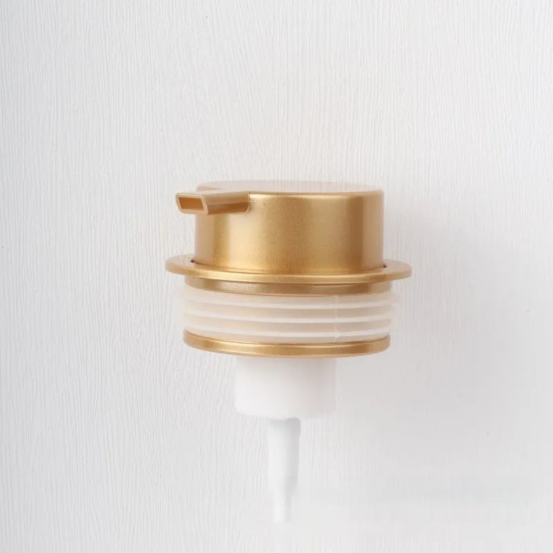 A large-headed foam pump for soap in a metallic gold finish, made from ABS plastic.