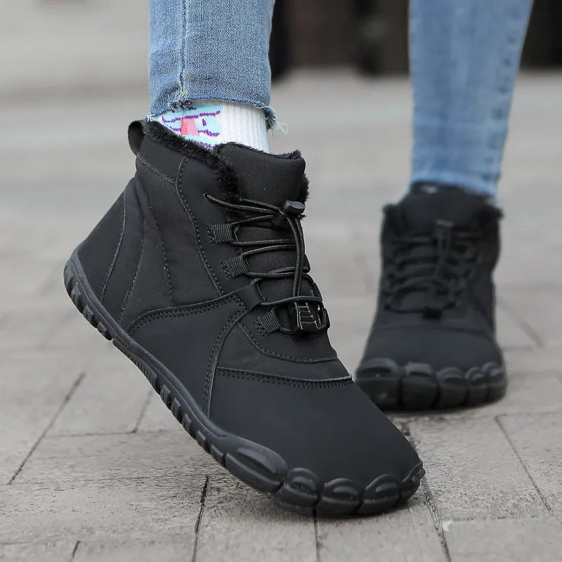 Black waterproof snow boots with lace-up front, fleece lining, and rubber sole on a winter background