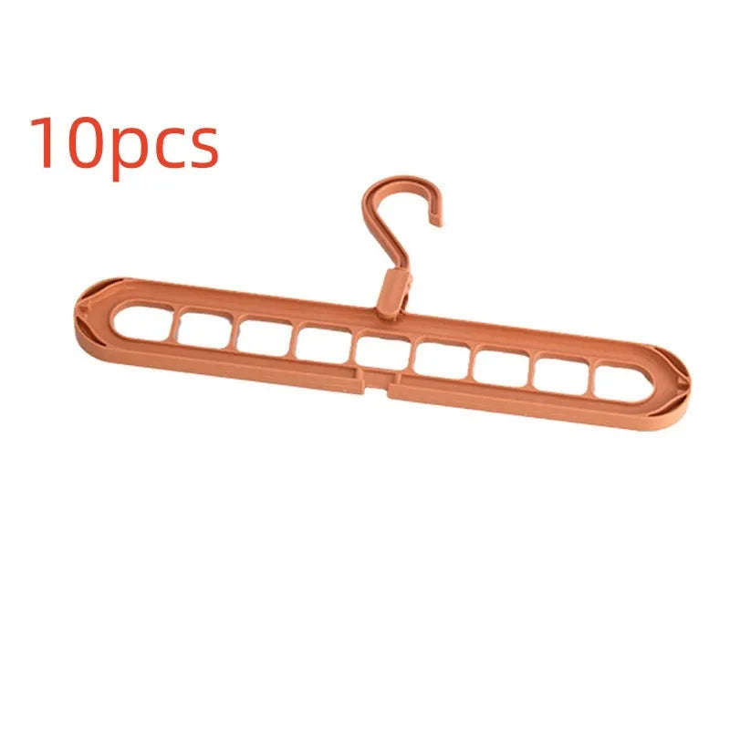Green plastic nine-hole folding pant hanger for trousers and skirts.