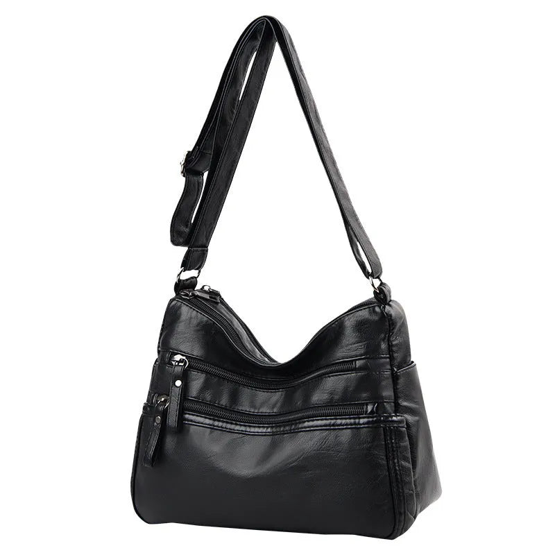 Women's washed leather crossbody bag in solid colour, retro messenger style with adjustable strap and soft handle