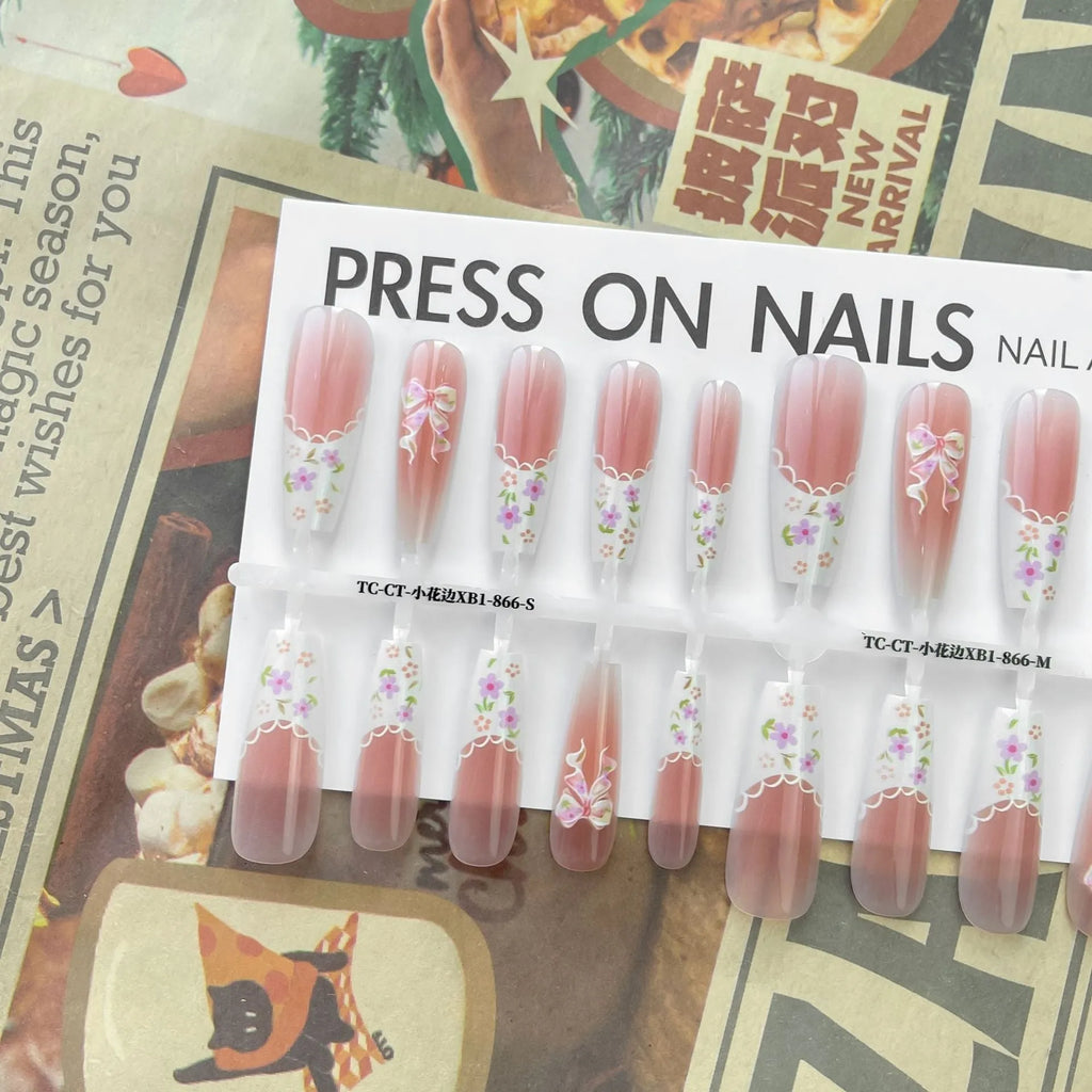 Set of 40 small floral prefabricated nail tips with long ladder velvet seal layer in white, displayed on a flat surface