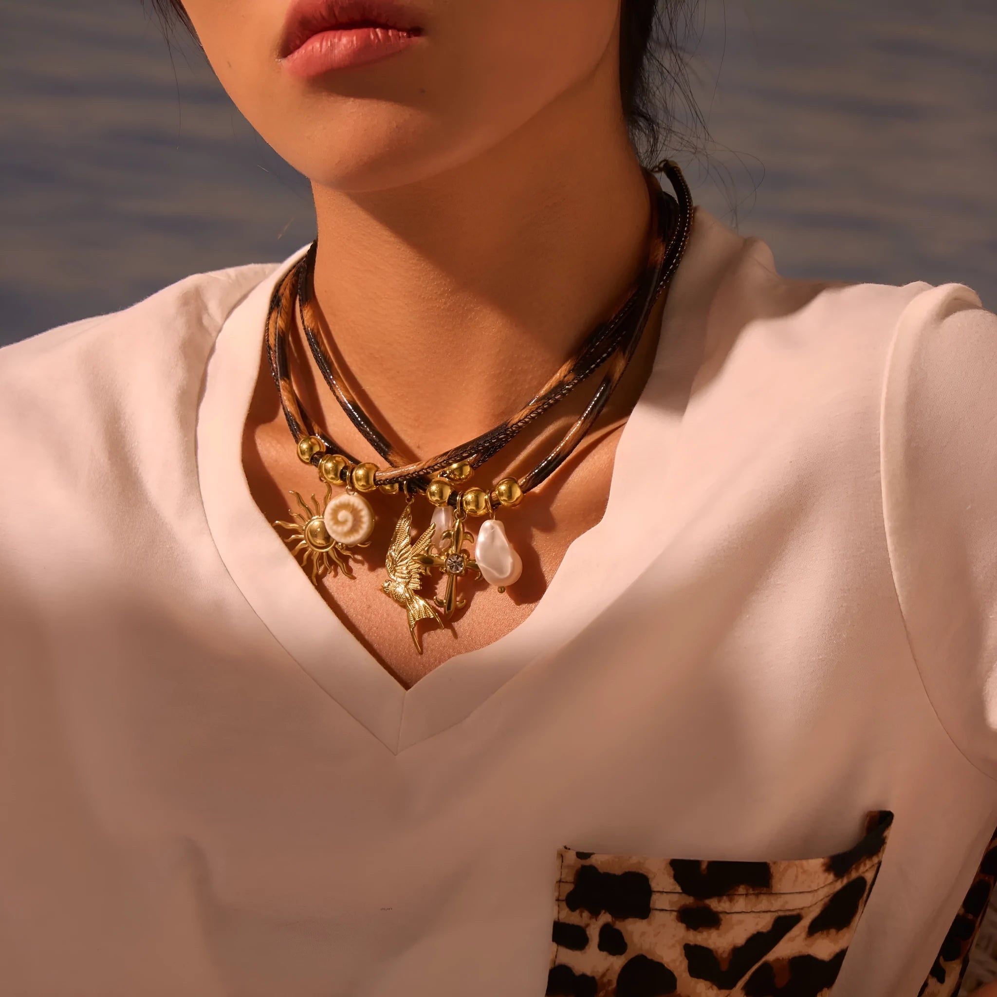 Geometric leopard print pendant on a gold-toned stainless steel necklace for women.