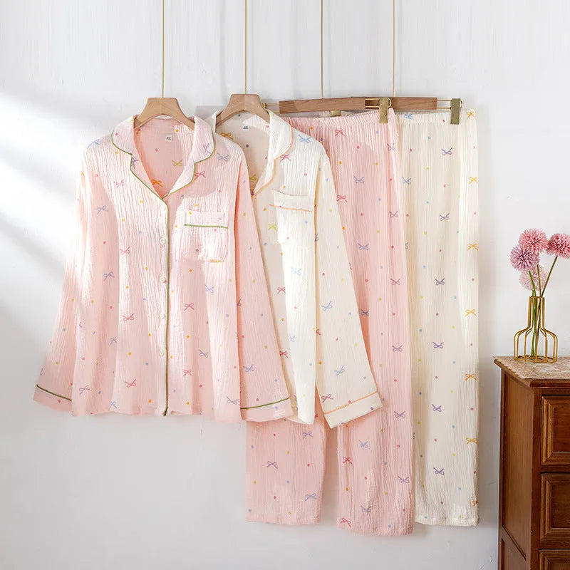 Women's beige long sleeve cotton pajama set with trousers, laid flat.