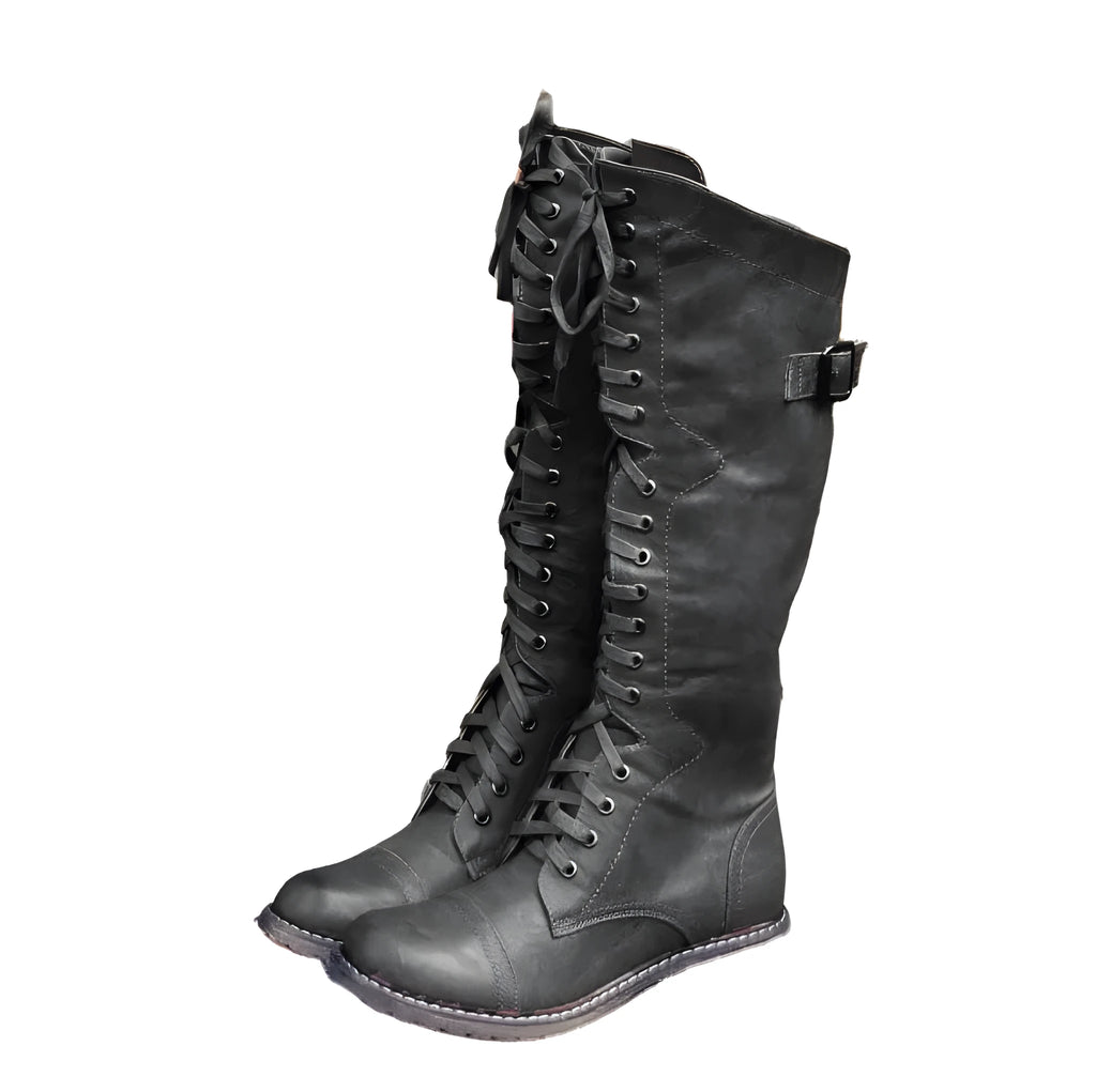 Women's black artificial PU knight boots with cross straps over the ankle.