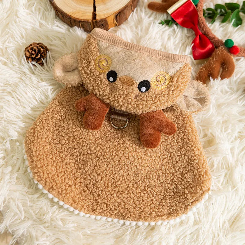Cat wearing a green granular-velvet Christmas cape coat with a tree-shaped hat and star