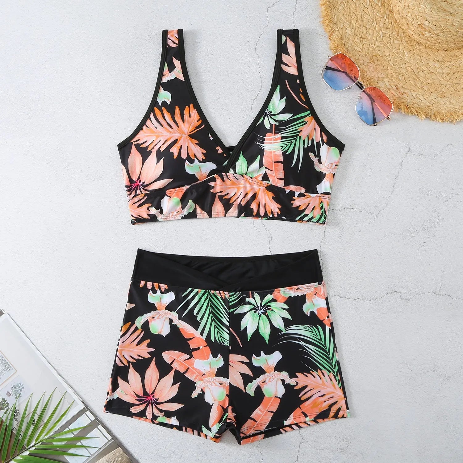 Women's two-piece printed swimsuit with high-neck top and boxer shorts in a multi-colour design.