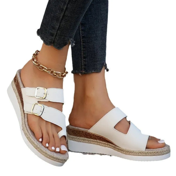 White women's wedge sandals with woven patent leather upper, peep toe, and finger-fit design on a rubber sole.