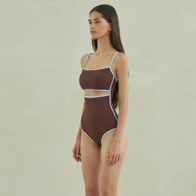 Brown triangle one-piece swimsuit for women on a hanger, showing front design.