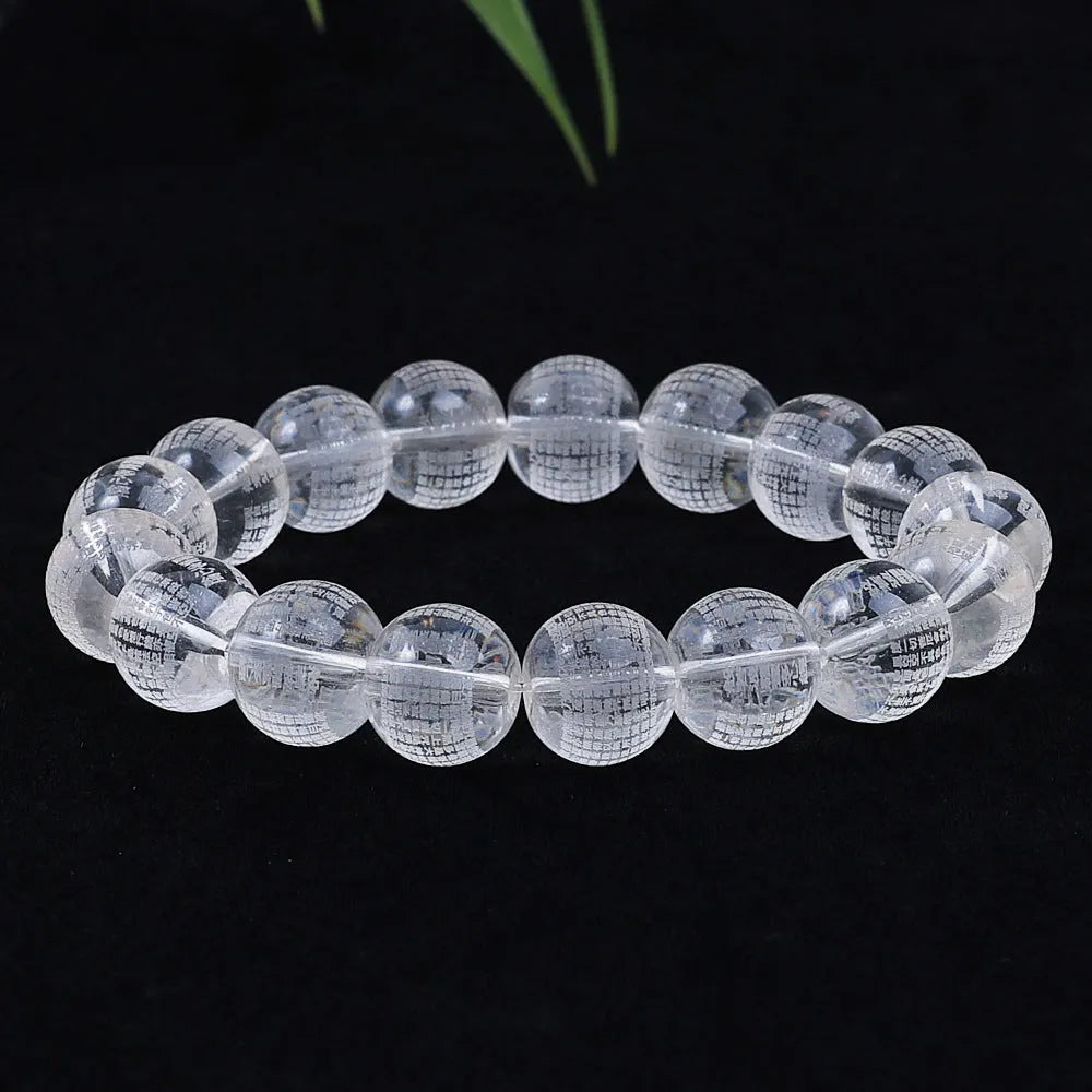 Ten round 10mm coloured glaze beads with Buddhist mantra text on a white background.